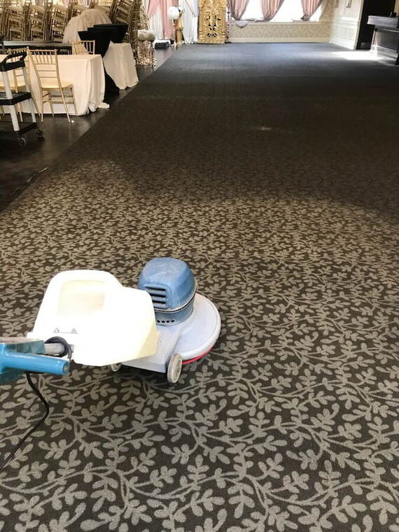 Overnight crew running a floor machine in an empty office