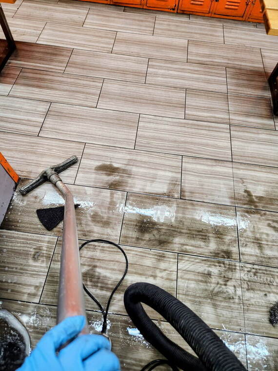 Hot-water extraction pulling grease from quarry tile grout lines
